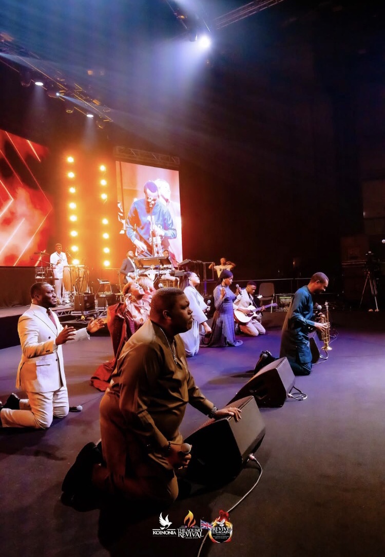 music ministers kneel on stage