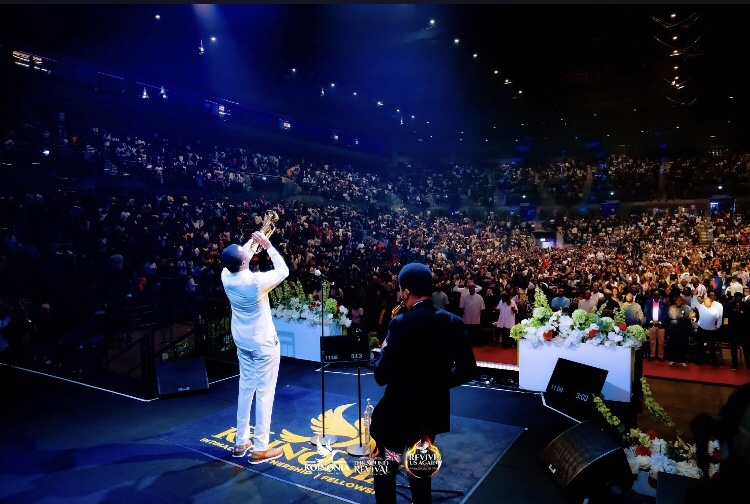 Pastor Nathaniel Bassey blows the trumpet in worship
