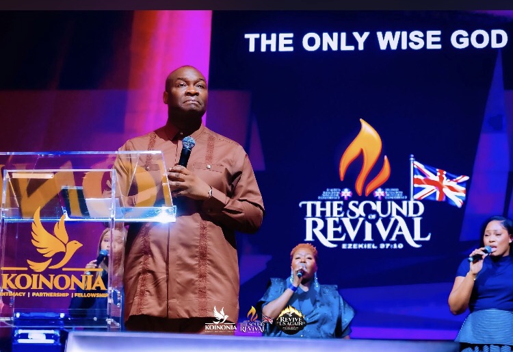 Apostle Joshua on stage with worship team
